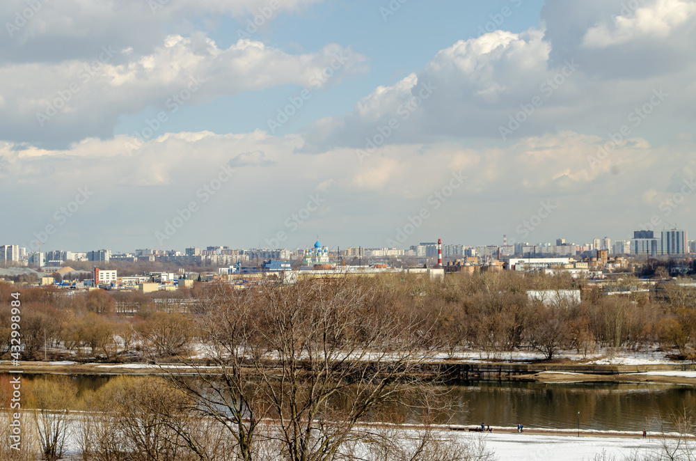 River, panorama of the city from the high bank of the river. Spring landscape. River in the city. High-rise buildings across the river