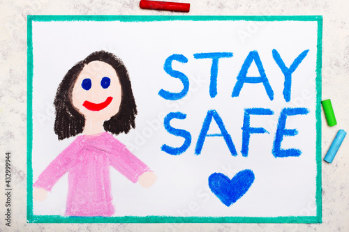 Photo of colorful drawing: Smiling girl and words Stay Safe