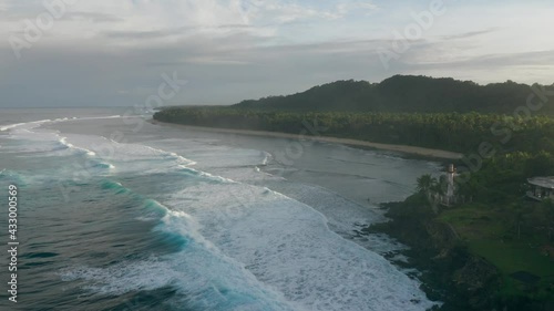 Beach Cove Drone Approach during SUNSET with cloud mist at Pacifico Beach Siargao Philippines