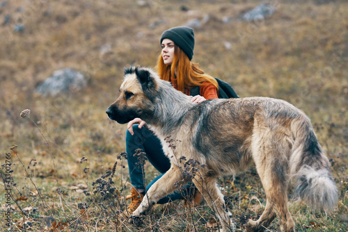 woman hiker next to dog in mountains travel vacation landscape © SHOTPRIME STUDIO