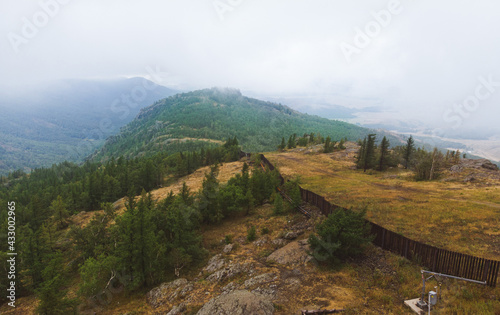 Foggy evergreen fir forest on a hilltop among the mountains of the National Park of the Republic of Bashkortostan on Lake Bannoye © xartproduction