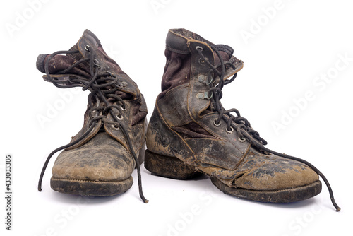 Old and broken boots isolated on white background