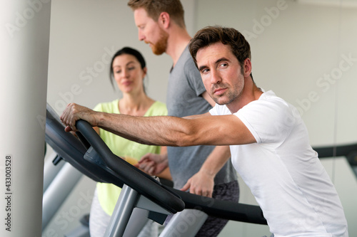 Young fit people cardio workout at gym
