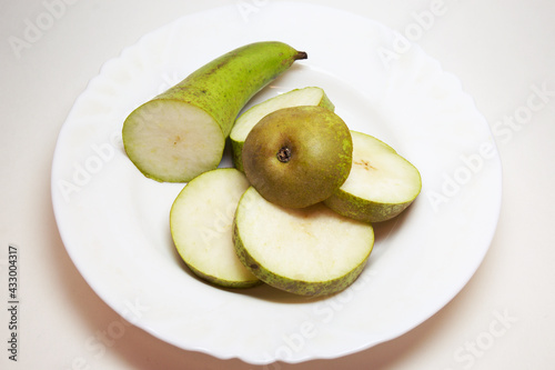 pear conference, cut into thin slices, beautifully arranged on white plate. back and front parts are bigger