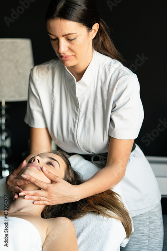 Young beautiful female in beauty salon getting spa massage