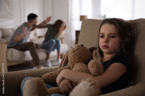 Фотография Couple fighting at home, focus on their unhappy little daughter