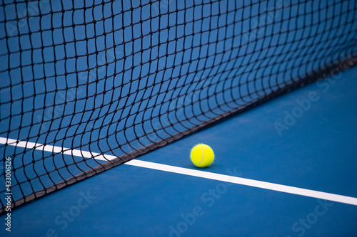  Tennis net and ball and hard court. Professional sport and tennis competition concept
