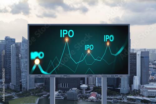 IPO icon hologram on road billboard over sunset panorama city view of Singapore. The hub of initial public offering in Southeast Asia. The concept of exceeding business opportunities.