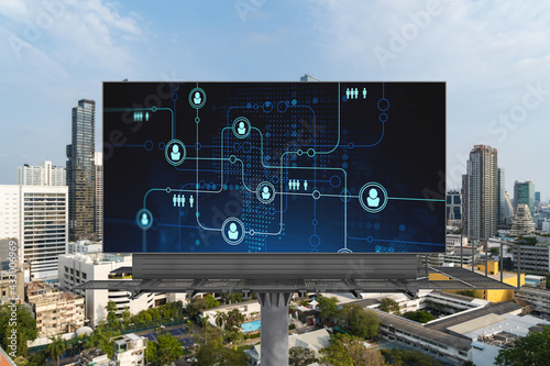 Glowing Social media icons on road billboard over panoramic city view of Bangkok, Southeast Asia. The concept of networking and establishing new connections between people and businesses.