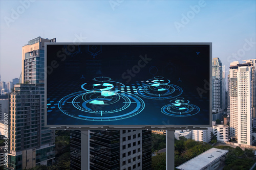 Glowing hologram of technological process on billboard, aerial panoramic cityscape of Bangkok at sunset. The largest innovative hub of tech services in Southeast Asia. photo