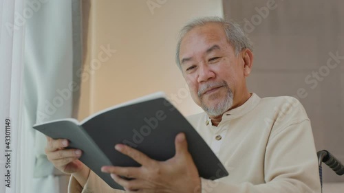 Wallpaper Mural Asian old man reading book while sitting on wheelchair in nursing home Torontodigital.ca