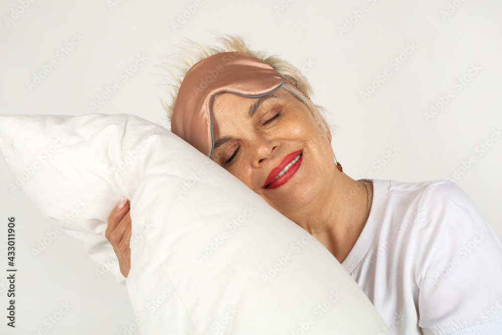 beautiful adult woman aged with a pillow on a white background beautiful adult woman aged with a pillow on a white background