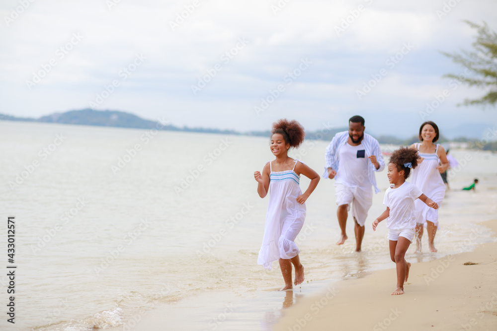 Happy African family walking relax on the beach with 2 daughters. Happy African family walking relax on the beach with 2 daughters.