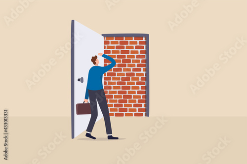 Business dead end, no way to exit or big mistake and wrong decision, obstacle and difficulty to overcome concept, businessman open exit door and found brick wall blocking the way.