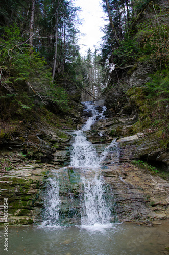 Mountain forest river water landscape. Waterfall in Carpathian Mountains, Ukraine.