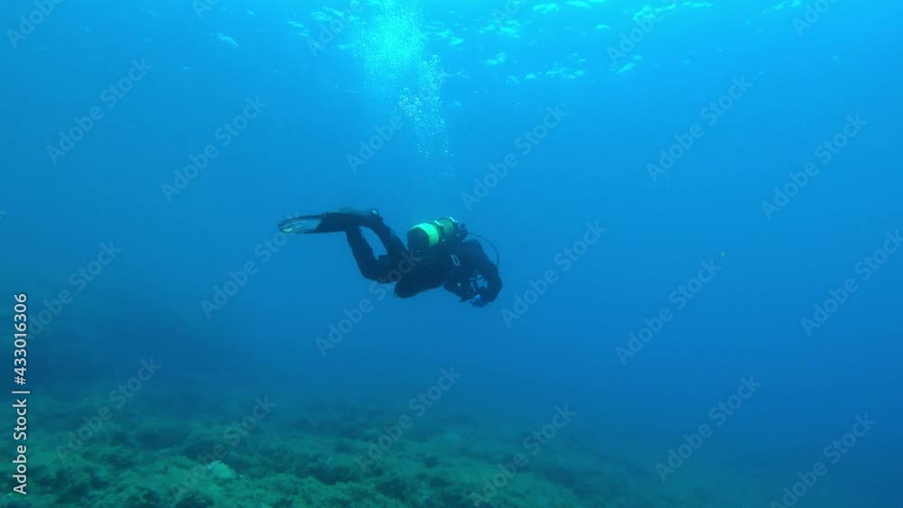 Underwater scene - Scuba diver in shallow water Underwater scene - Scuba diver in shallow water