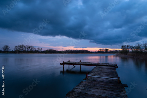 Fishing pier on the lake and the evening sky