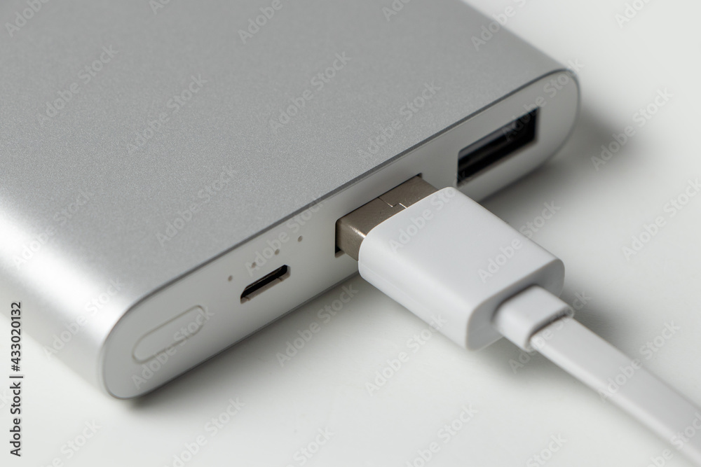 Power bank for charging mobile devices. White smart phone charger with power bank battery bank . External battery for mobile devices. Power bank for charging mobile devices. White smart phone charger with power bank battery bank . External battery for mobile devices.