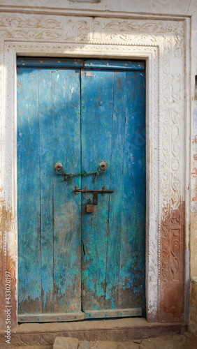 Vertical shot of a blue door in the Neemrana Baori stepwell in Rajasthan, India photo