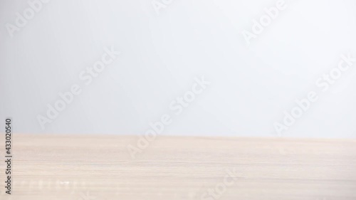 Close up view of person hand holding hammer and smashing alarm clock. Anger management and hating mornings concept.