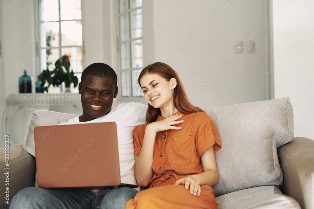 man and woman sitting at home in front of laptop entertainment leisure man and woman sitting at home in front of laptop entertainment leisure