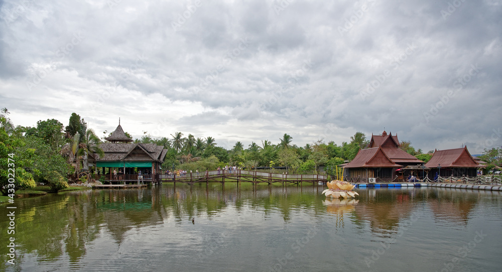 Lake in the park. Tourists drink tea and look at fish in the water Lake in the park. Tourists drink tea and look at fish in the water