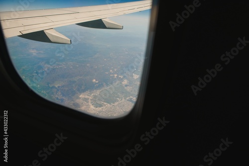 Looking through window aircraft during flight in wing with a nice blue sky