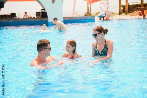 Happy family in swimming pool at water park © Serhii