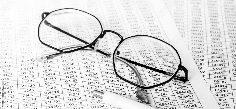 finance business calculation with glasses, tables with numbers and pen. business concept. financial literacy. accounting of income and expenses finance business calculation with glasses, tables with numbers and pen. business concept. financial literacy. accounting of income and expenses