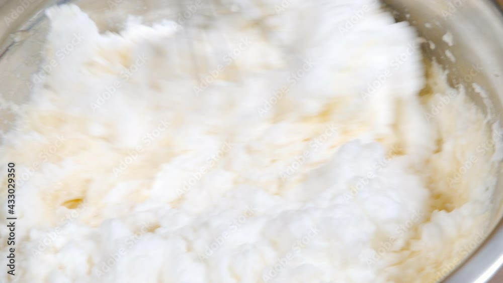 Close-up of the process of kneading dough using a whisk. Making biscuits or muffins.