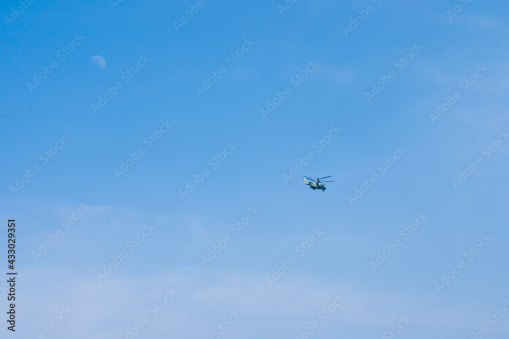 A helicopter flying across the sky A helicopter flying across the sky