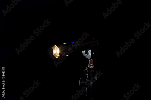 Flashlight and beam of light on a black background