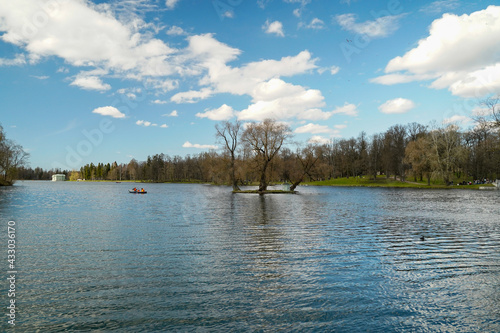 An island in the middle of a river  pond   on which there is a small house