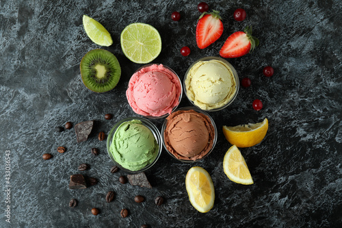 Fruit ice cream and ingredients on black smokey background