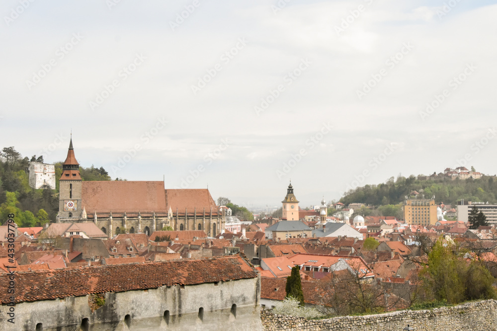 Brasov old city center with beautiful landmarks black church, old city council and hilltop citadel
