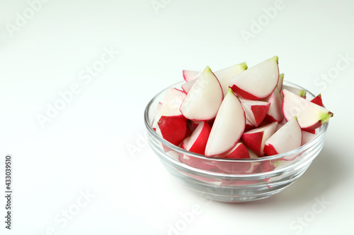 Bowl of fresh radish on white background, space for text