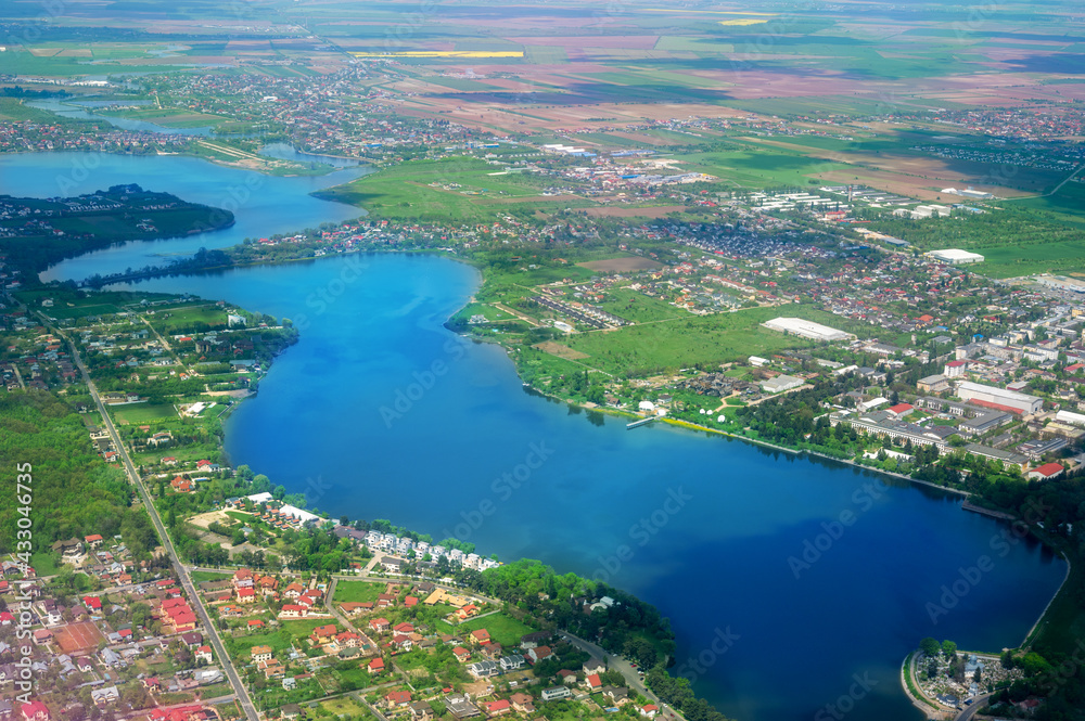 Aerial landscape view of a rural surroundings area and a blue river in Bucharest, Romania