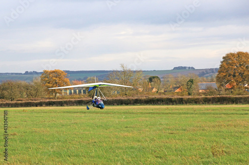 Valokuva Ultralight airplane landing on a grass strip