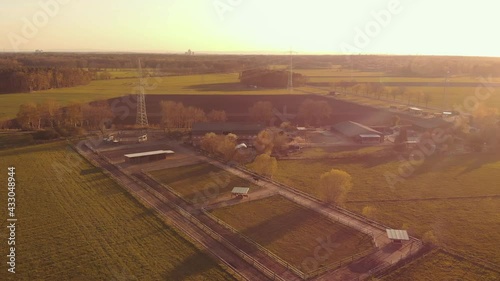 aerial push-in of a farm ranch at sunset