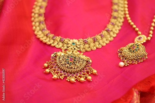 gold necklace on a red background