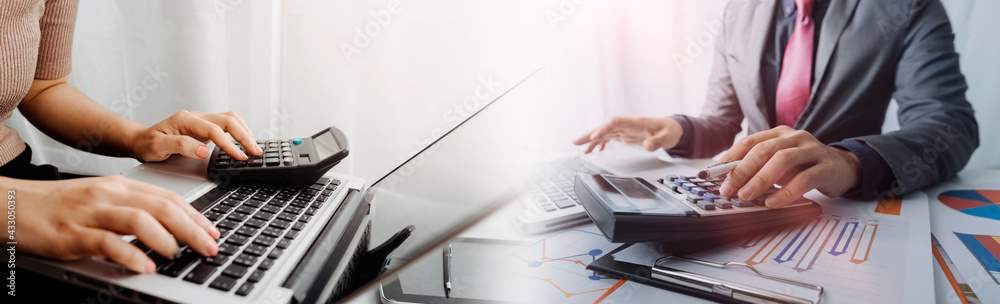 Attractive business woman working in office sitting at desk analyzing statistics holding documents diagrams and charts using laptop at office. smart woman concept. Attractive business woman working in office sitting at desk analyzing statistics holding documents diagrams and charts using laptop at office. smart woman concept.
