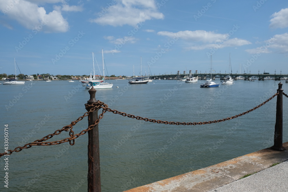 Chain link fence with the harbor and boats in the backround