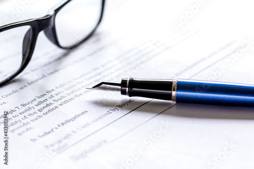 workspace with document, glasses and pen for sign for businessman day