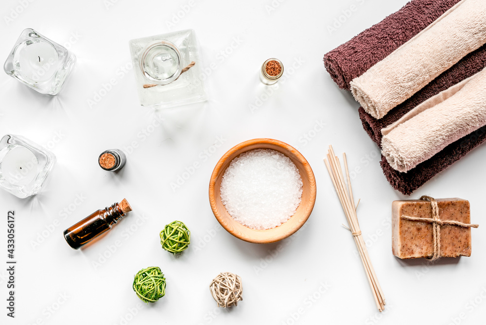 spa cosmetics with soap, salt, oil on white background top view spa cosmetics with soap, salt, oil on white background top view
