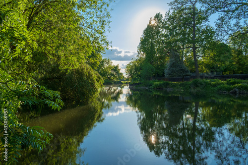 The River Mole  Near Esher  Surrey  England  UK. The tree-lined river and still water creates a tranquil scene.
