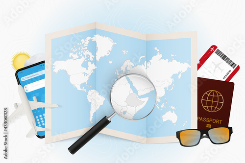 Travel destination Ethiopia, tourism mockup with travel equipment and world map with magnifying glass on a Ethiopia.