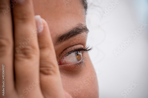 Portrait latin woman. Curly girl with light eyes 