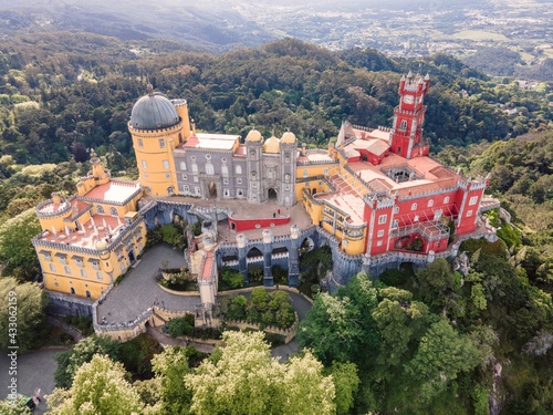 Картината върху платно Aerial view of Pena Palace, a colourful Romanticist castle building on hilltop during a beautiful sunset, Sintra, Lisbon, Portugal