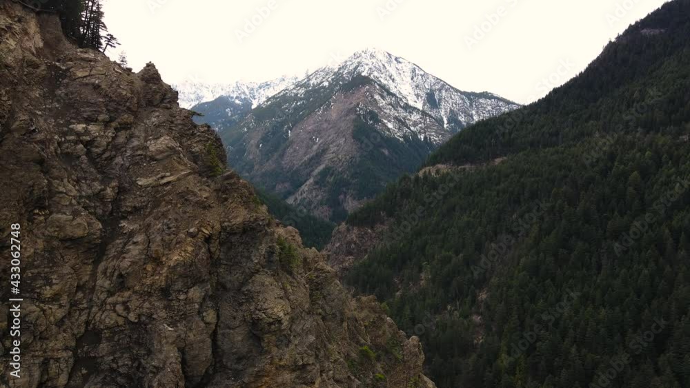 Slow aerial drone shot over river cutting through a canyon near Duffey Lake in British Columbia.