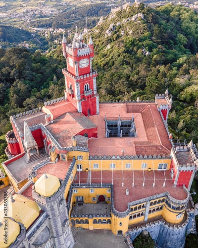 Фотография Aerial view of Pena Castle clock tower with forest in background, view of the Romanticist castle on hilltop, Sintra, Lisbon, Portugal